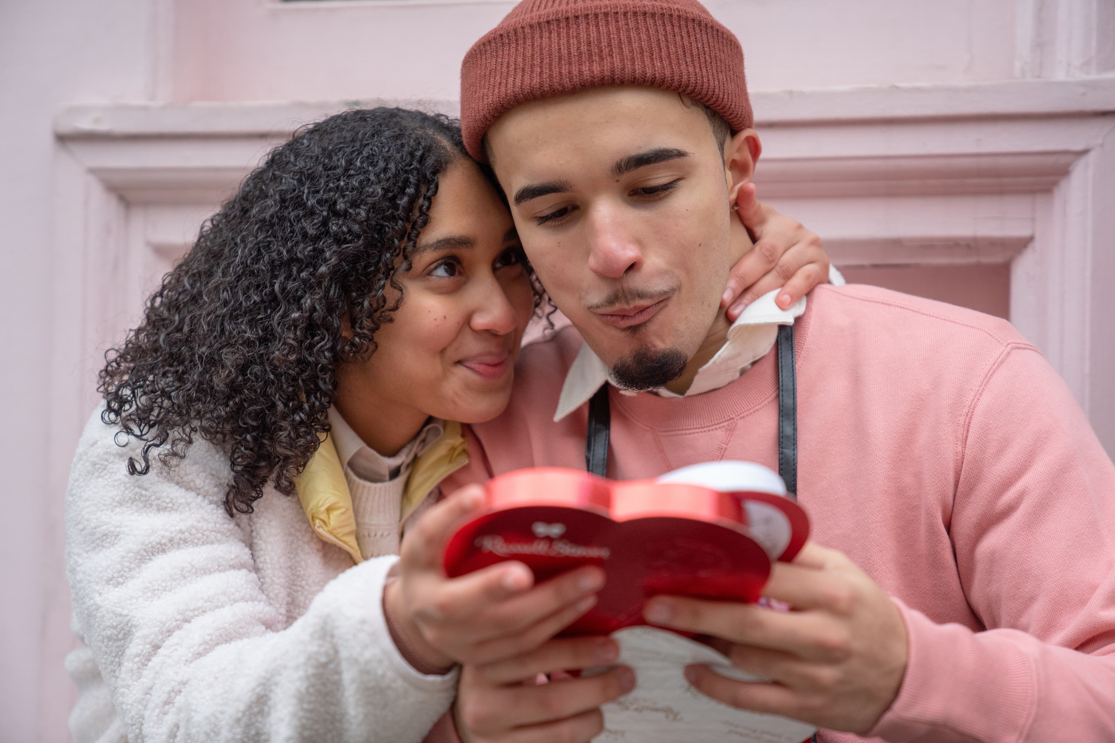 young couple exchanging valentines day gift 