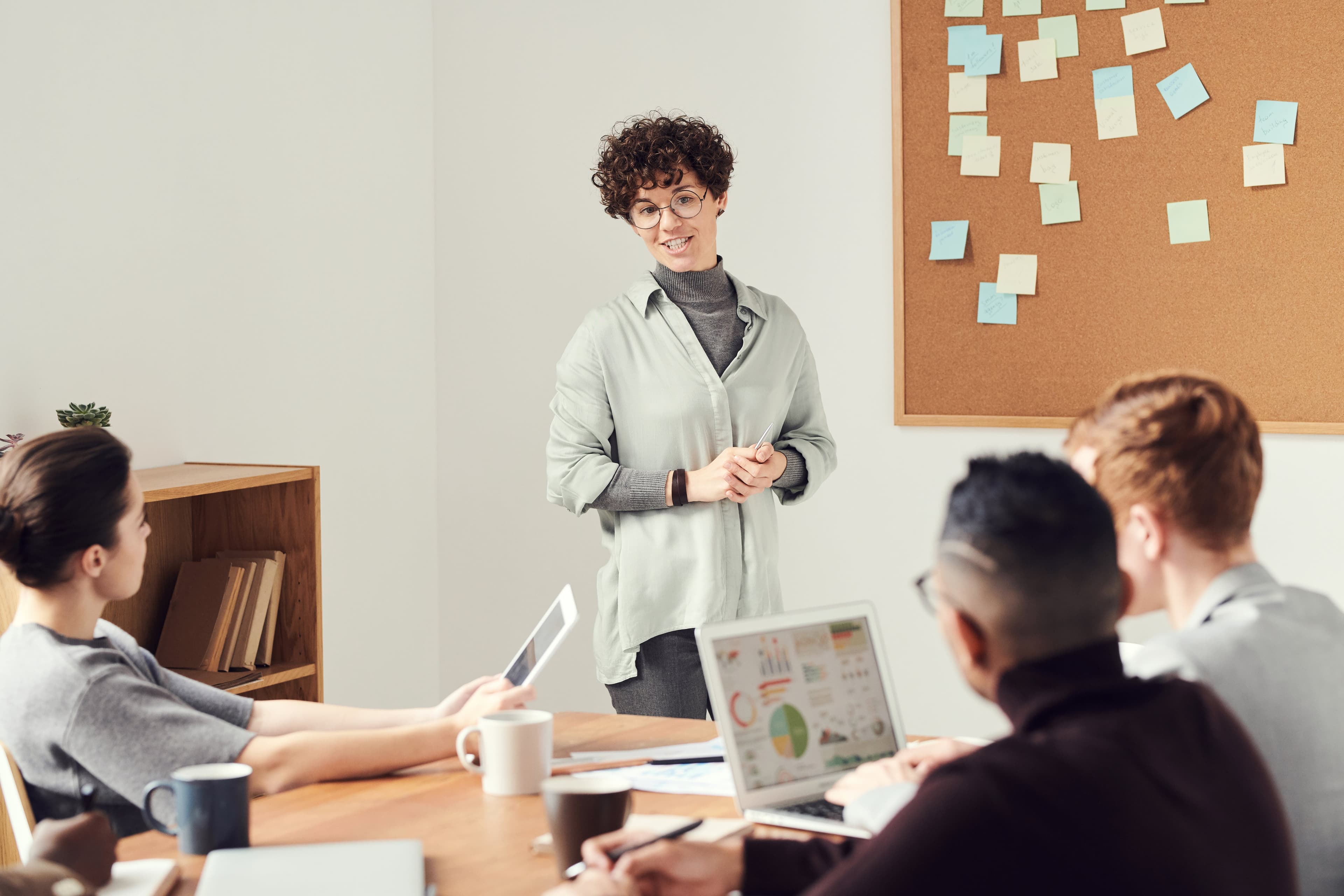 corporate retail professional leading a team meeting in a boardroom