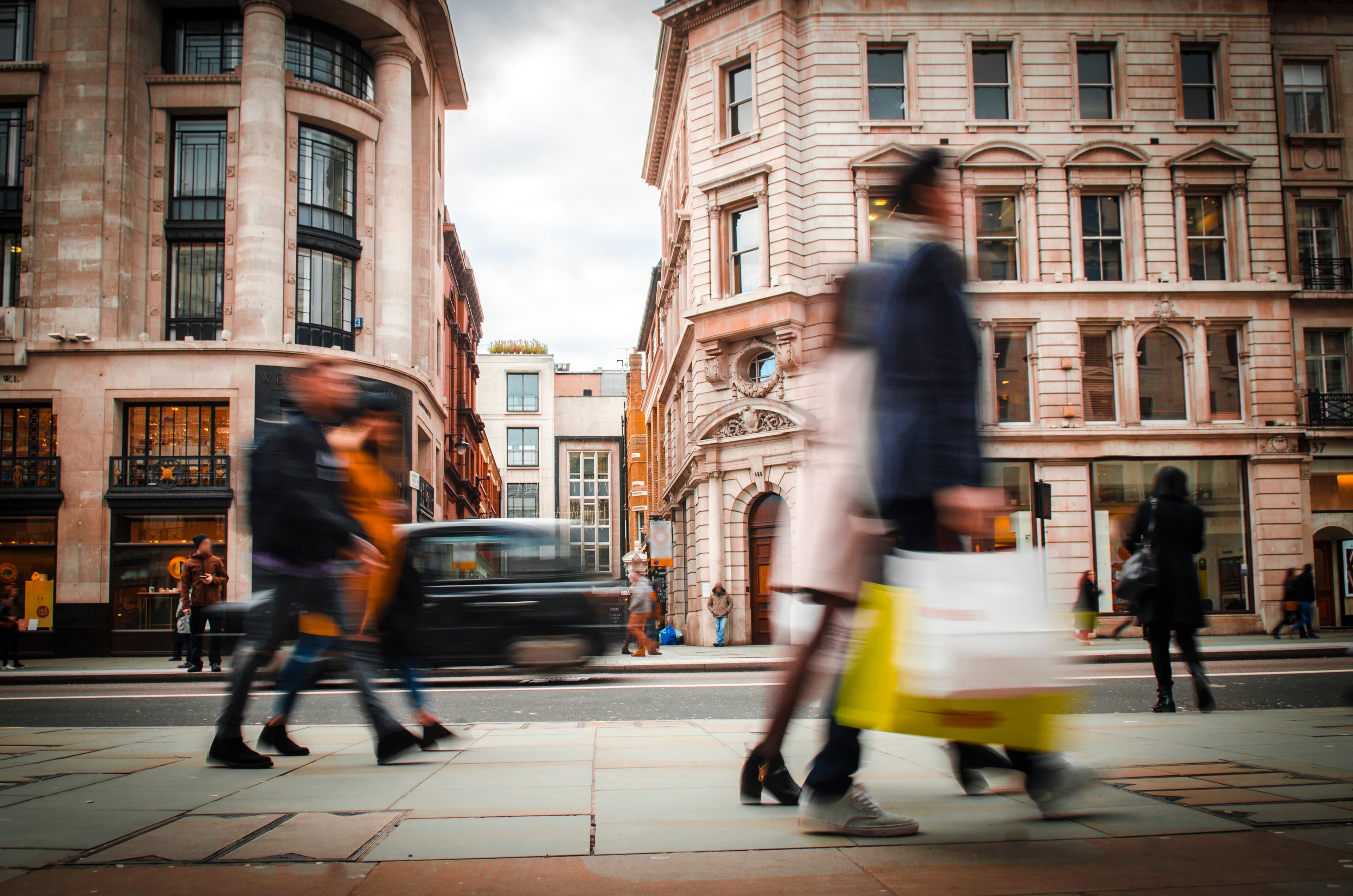 Motion blurred shoppers carrying shopping bags on Regent Street, London.