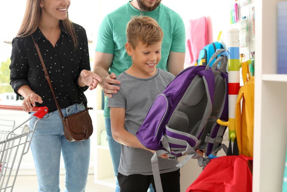 family in store doing back-to-school shopping 