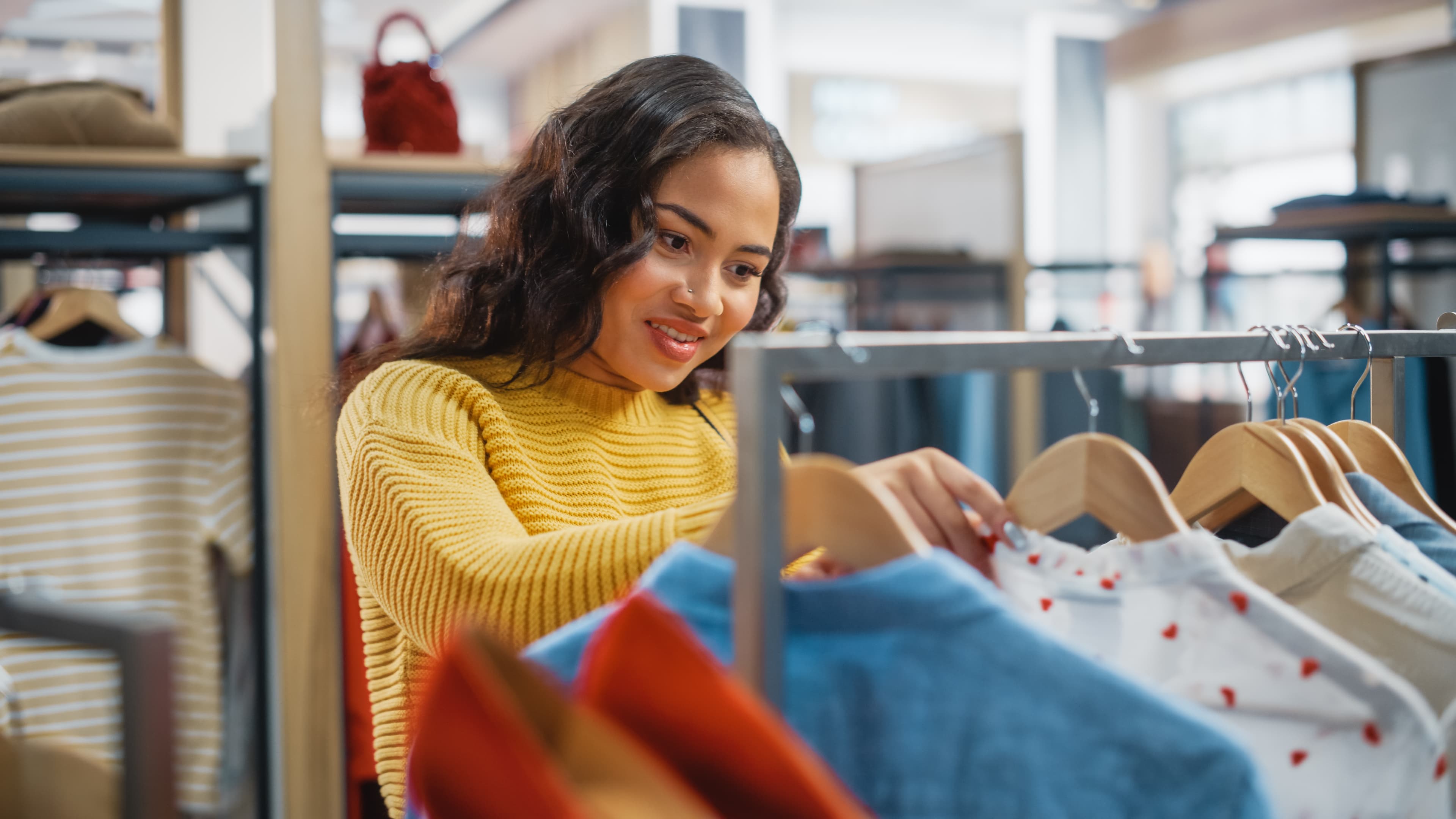 Smiling Female Customer Shopping in Clothing Store, Choosing Stylish Clothes