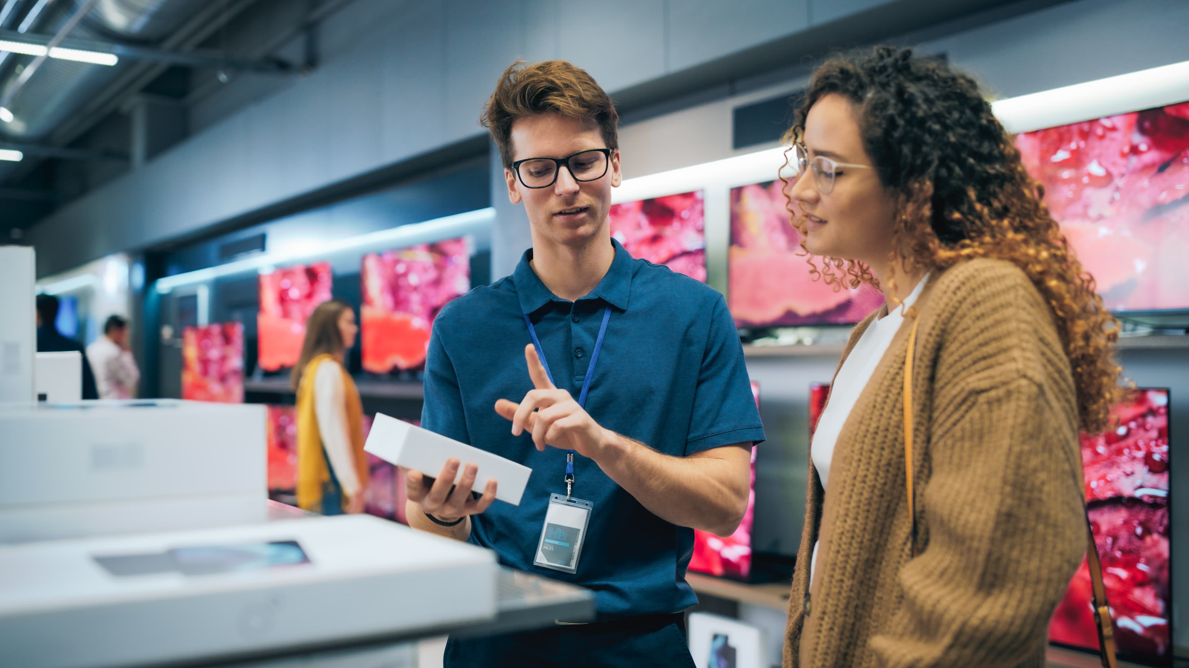 Portrait of Female Customer Seeking Advice from Retail Home Electronics Expert.